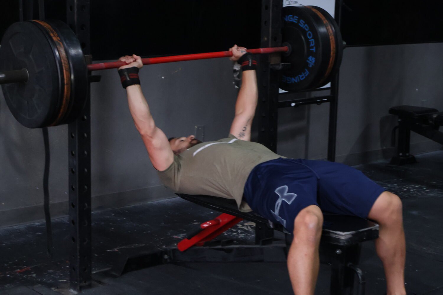 Athlete bench pressing on strength day